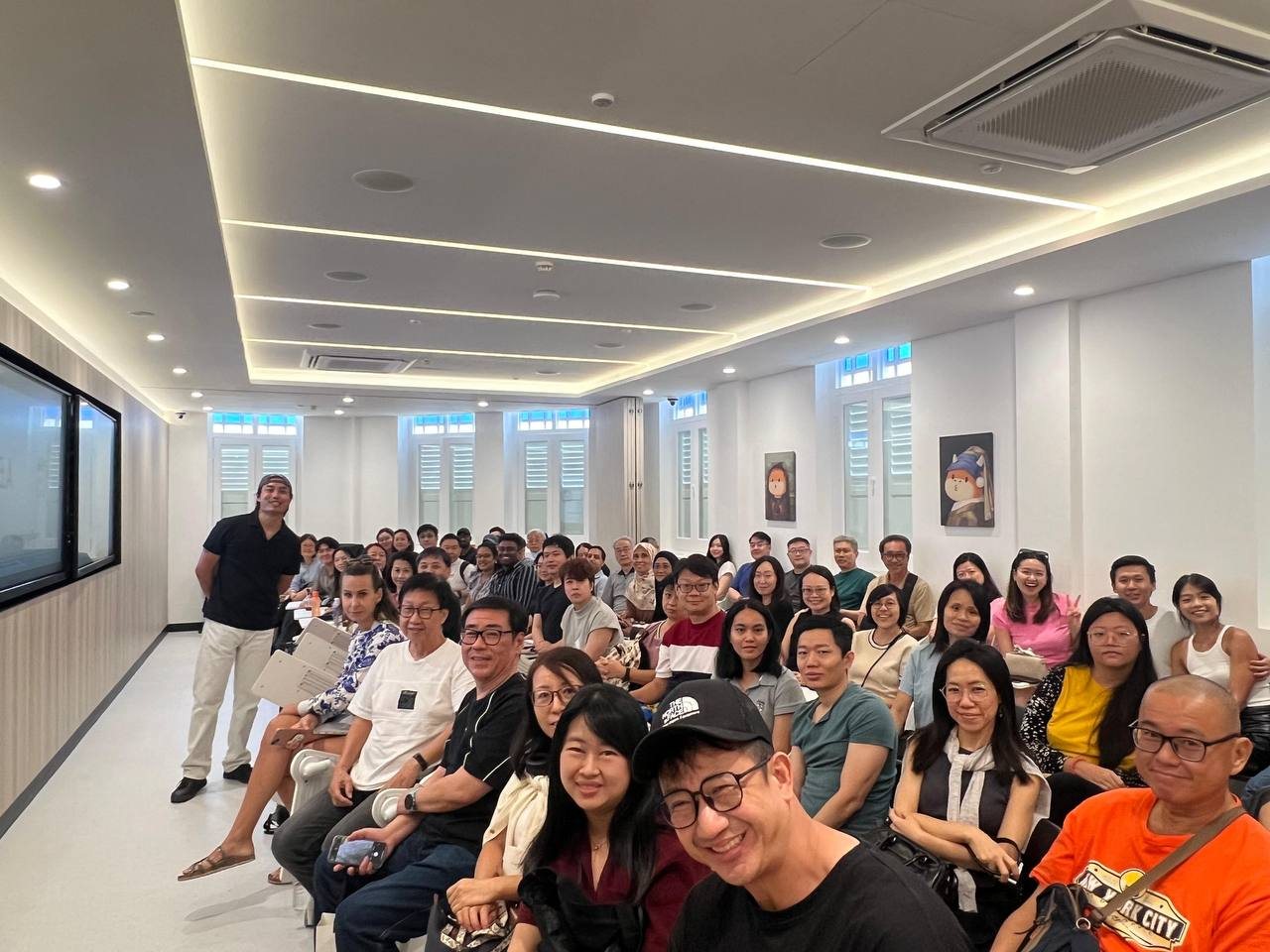 Jiax speaking about miles and investing to a full room